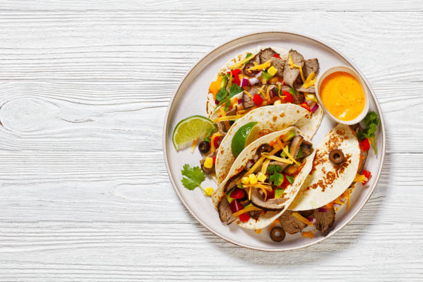 istock Beef Steak Tacos with veggies, avocado, corn 1486604179