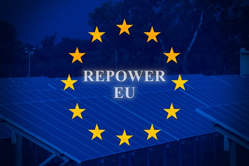 European flag with Solar Panels as background and the text Repower Eu