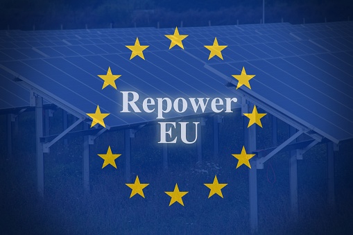 European flag with Solar panels as background and the text repower Eu