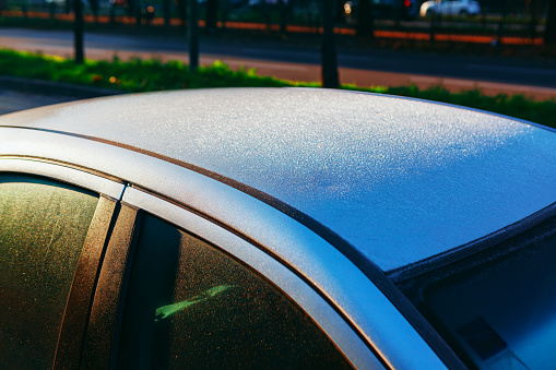 Frost on car roof . Frozen water on a car rooftop