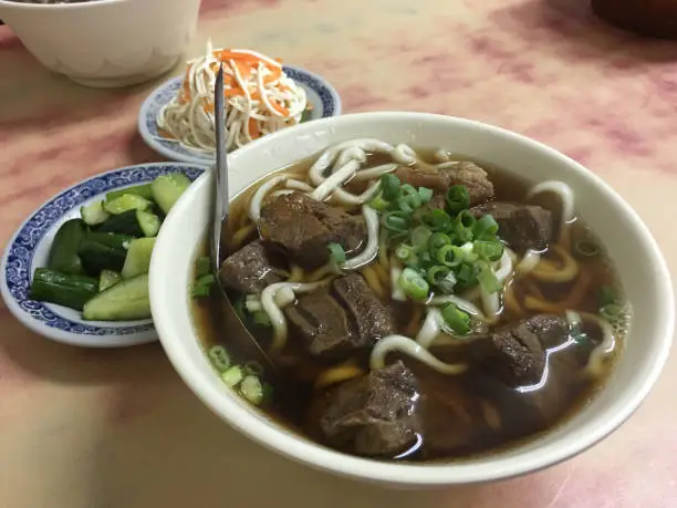 Traditional Taiwanese beef noodle soup with marinated cucumbers and shredded bean curd.  A delicious comfort food.