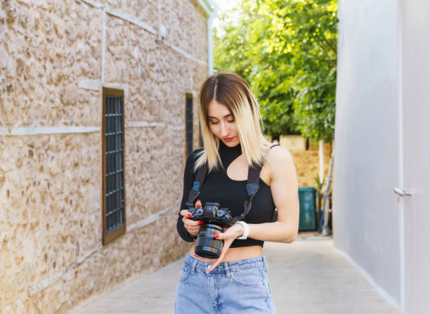 young beautiful woman taking pictures in the streets of old town, kaleici antalya - reportage photographer photographing street imagens e fotografias de stock