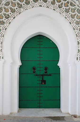 Ornated doors in a Madrasa in Marakesh, Morocco.
