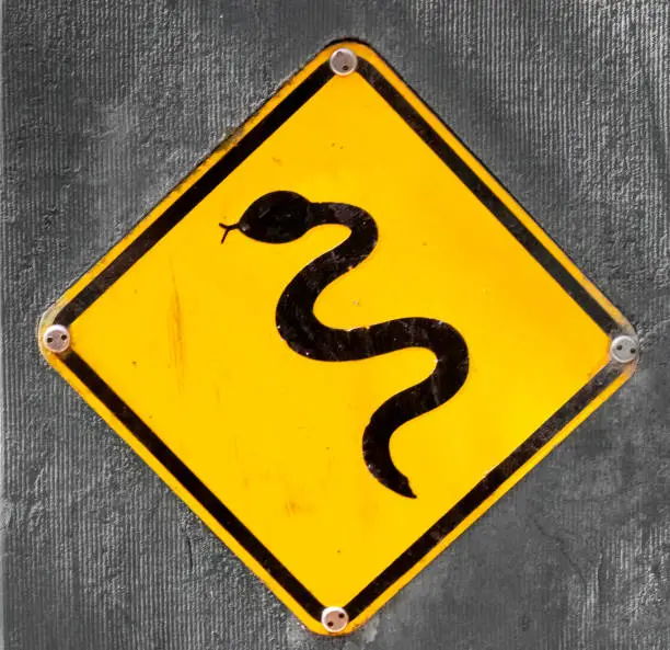 Photo of A common sign warning about venomous snakes along walking and hiking trails in the Great Otway National Park, Great Ocean Road, Victoria, Australia