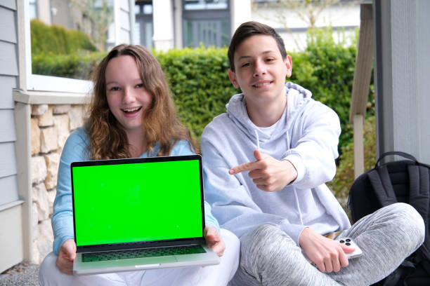 istock prompting solution of problem boy and girl sitting on street doing school assignments portfolio notebook folder with sheets pencil Two cups of tea coffee pleasant relationship teenager boy 1486616687