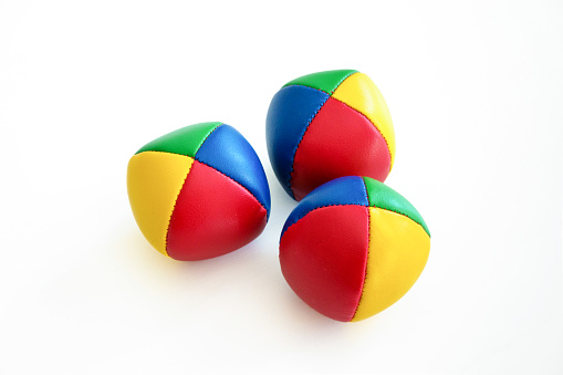 Three colorful juggling balls against white background