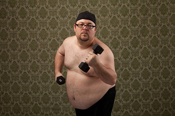 istock overweight white male working out to get in shape 148661865
