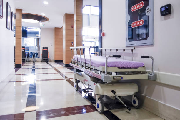 Long corridor in hospital with surgical beds Long corridor in hospital with surgical beds emergency services equipment stock pictures, royalty-free photos & images