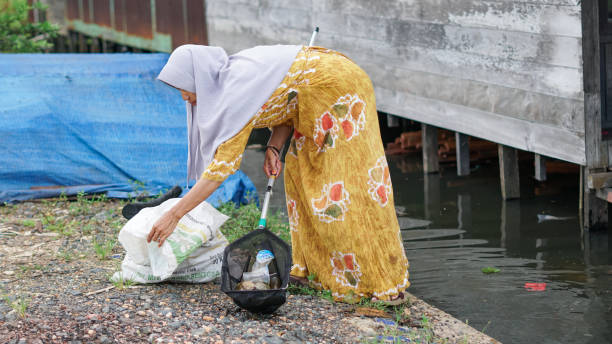 istock women clean up trash around the house with trash nets 1486629147