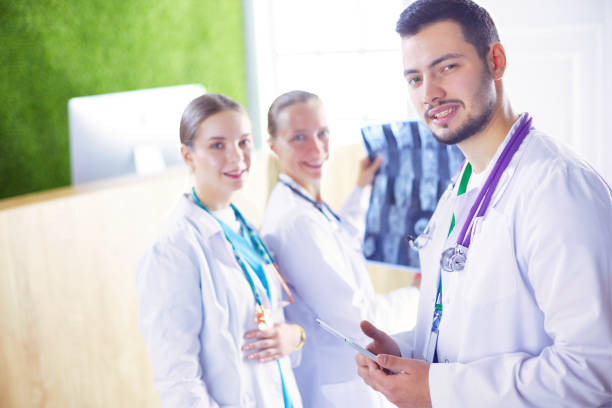 istock Group of doctors and nurses looking at X-ray 1486636007