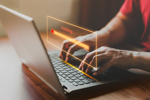 istock Adult man using a laptop computer for download software and waiting to loading digital business data form website, very slow internet form wifi. Concept of waiting for load of loading symbol. 1486649970