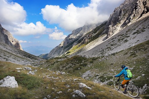 A man descending a trail in the Maone Valley, on the Gran Sasso Range, in Abruzzo, Italy