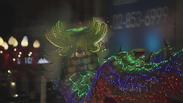 lighted chinese dragon dance in night time ,chiness lantern decorated.happy chinese day festival.Lion dance.