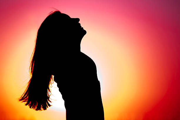 istock Woman relaxing at sunset 148665278