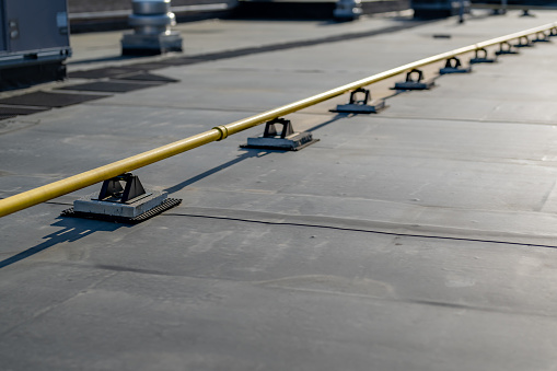 Photo of a yellow gas pipe on a new EPDM on a large commercial building