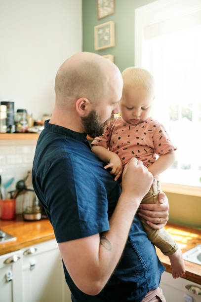 istock Father, kitchen and dad care for his kid in a home bonding, relax and feeling calm together in a house. Caring, single parent and man person showing kid happiness, happy and support as way of love 1486653607