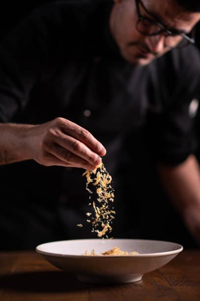 istock A male chef decorating a plate in a restaurant 1486653739