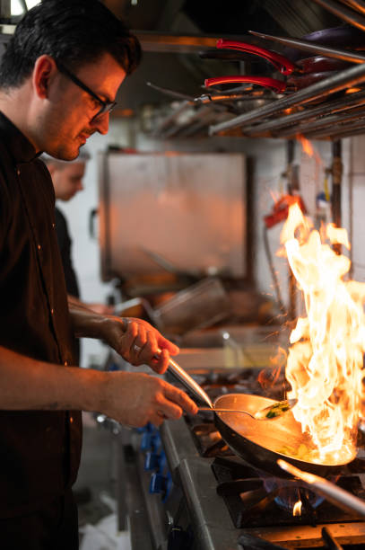 istock A male chef in restaurant kitchen at stove with pan 1486654610