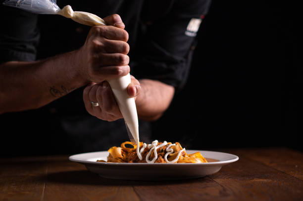 istock A male chef decorating a plate in a restaurant 1486654865