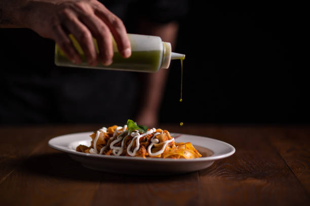istock A male chef decorating a plate in a restaurant 1486654893