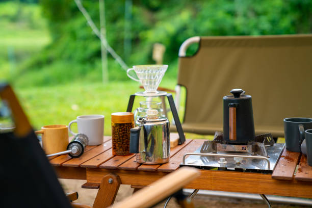 istock Group of Asian people having breakfast drinking coffee while camping together at nature park. 1486659461