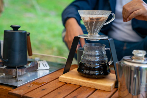 istock Group of Asian people having breakfast drinking coffee while camping together at nature park. 1486659509