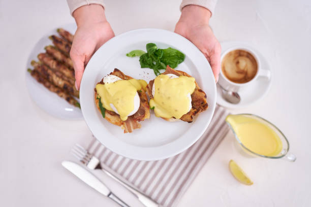 istock Tasty eggs Benedict, hollandaise sauce and aspargus covered with bacon 1486661045