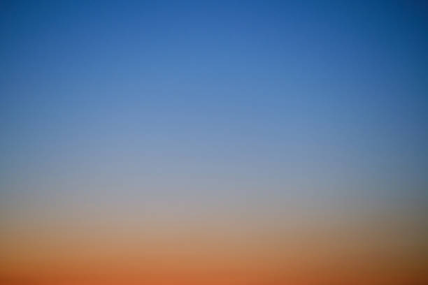 istock Sunset sky gradient from orange to blue, copy space. Clear sunset sky with the bright light of the setting sun 1486662474
