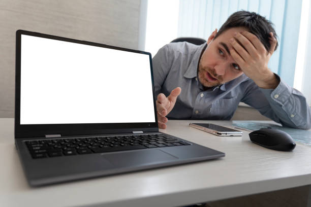 istock Thoughtful young 30s caucasian businessman in eyeglasses looking at computer screen, working distantly online at home office, solving problems, making difficult decision, freelance workday concept. 1486662517