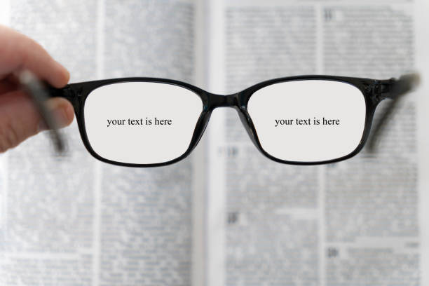 book and eye glasses for read and write over blurred background with copy space, selective focus. reading glasses in his hands on a blurry book background. poor vision concept. copy space for text