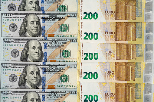 American money banknotes bills with European cash money banknotes, USA dollars, 100 dollars and 200 Euros papers exchange rate