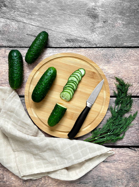 istock Green cucumbers cut with a knife 1486663486