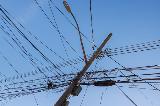Soft focus image of chaotic line on electric pole on walking street.