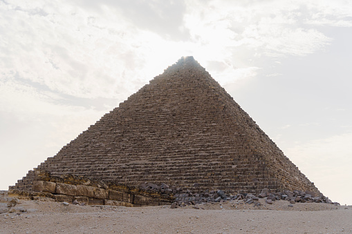 The great pyramid of Mikerina in Cairo, Egypt. Pyramids of Menkaura against the blue cloudy sky.