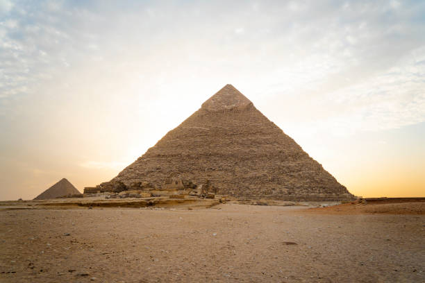 istock Archaeological complex of Great Egyptian Pyramids is located on the Giza plateau. second pyramid of Chephren khefren in the night light at sunset. sun sets behind the pyramid. 1486665710