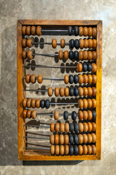 istock Hand wooden abacus lying on a stone table 1486670660