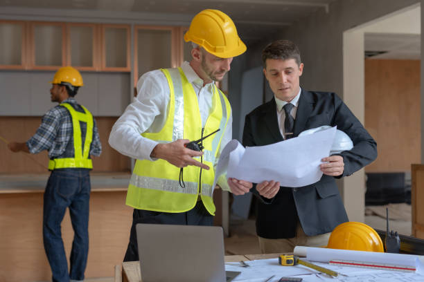 istock Architect and engineer work together with a sketch of the building and discussing it at the construction site. 1486674793