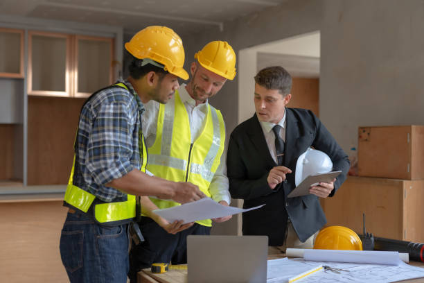 istock Architect and engineer work together with a sketch of the building and discussing it at the construction site. 1486674801
