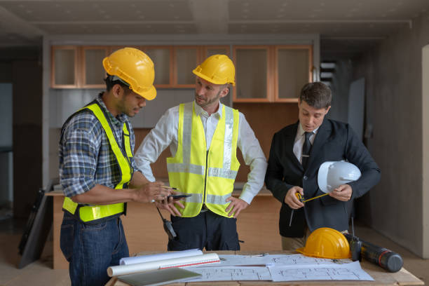 istock Architect and engineer work together with a sketch of the building and discussing it at the construction site. 1486674829