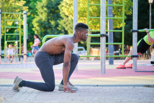 istock Young fit shirtless black man ready to run outdoors on sunny summer day. 1486674868