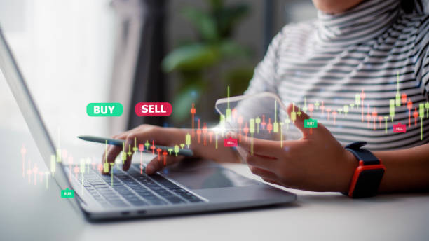 istock Women use laptops to analyze trading data on the futuristic virtual interface screens. smartphone with a stock exchange graph on the screen. Financial stock market. 1486681434