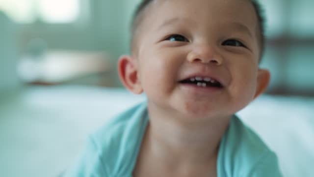 Close-up portrait of a sweet smiling little boy having growth development.