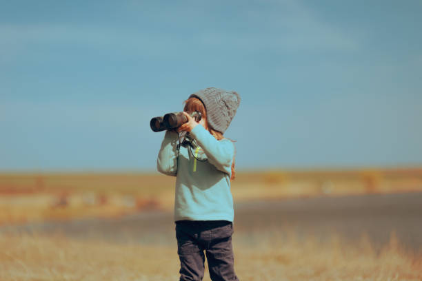 istock Explorer Toddler Girl Playing with a Pair of Binoculars 1486690432