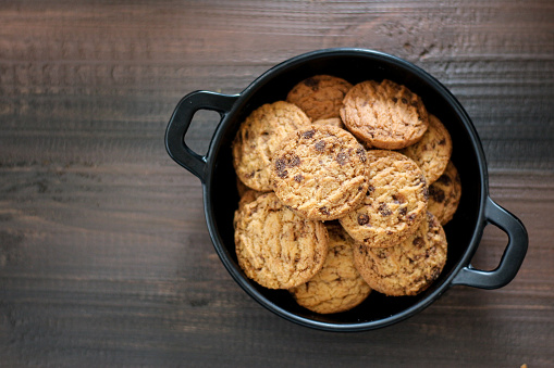 Chocolate cookies on a black pan. With copy space.