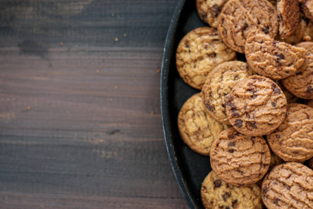 istock Chocolate cookies on a black pan. 1486694133