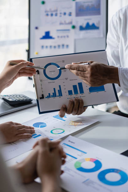 istock Young colleagues working together on startup projects in modern office business people are brainstorming analytical calculations vertical image 1486703373