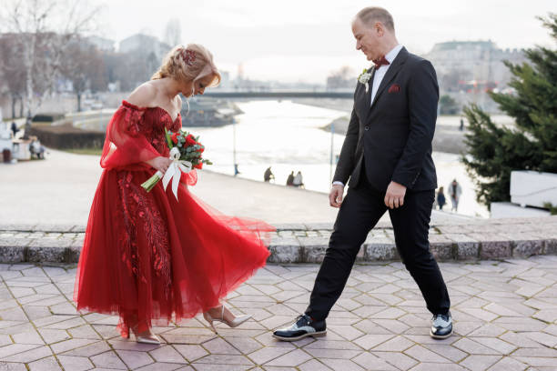 Happy mature wedding couple having fun on city quay