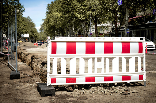 Close-up barrage plastic fence for fencing during construction or repair roads in the city.  The work of utilities to improve the infrastructure of the metropolis.