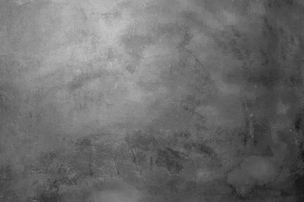 Photo of Gray decorative plaster. Spotted, scratched, rough background. Art wall texture. Abstract background for design.