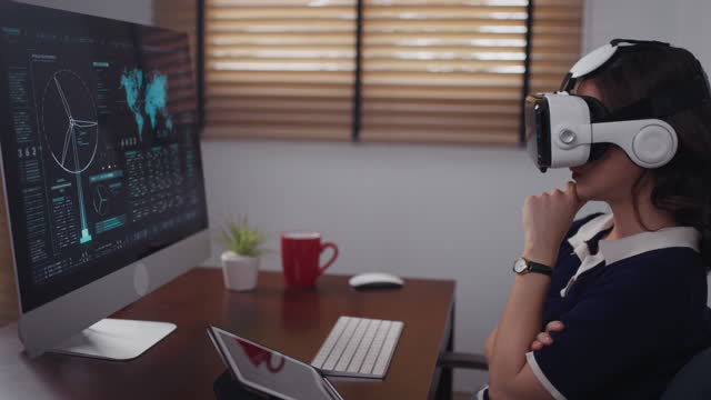 Futuristic women Engineer Wearing Virtual Reality Glasses working with a futuristic hologram to analysis and create alternative energy solutions with wind turbines